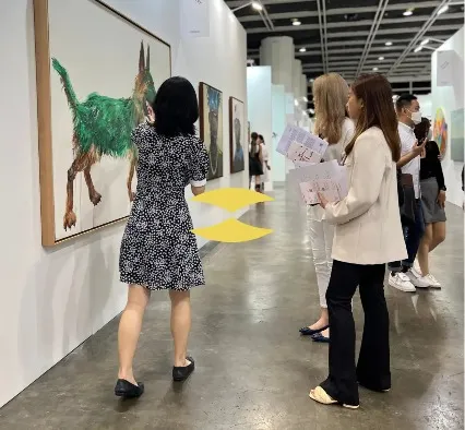 People engage with exhibits at an art gallery.