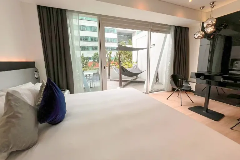 King bed and terrace in the Executive Room at Dorsett Changi City.