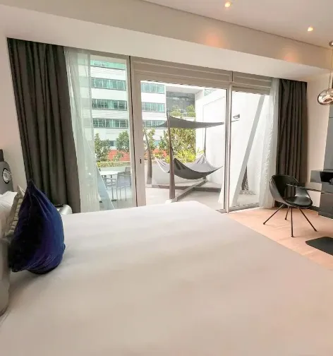 Bed facing the balcony at the Executive Room, Dorsett Changi City Singapore.