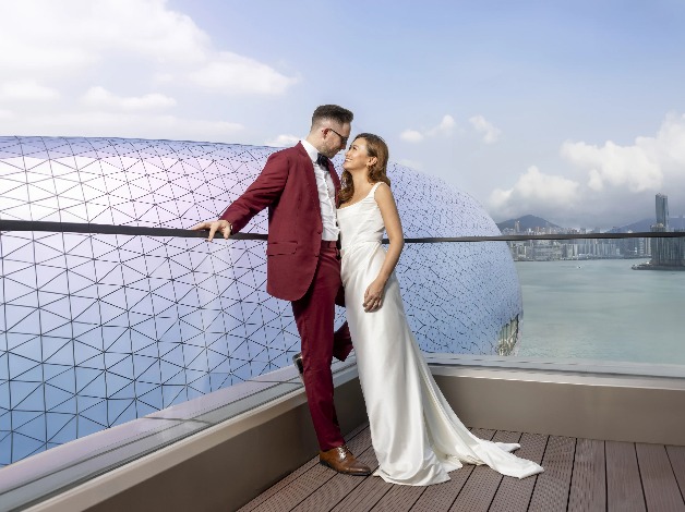 Couple in a balcony overlooking Kai Tak Sports Park.