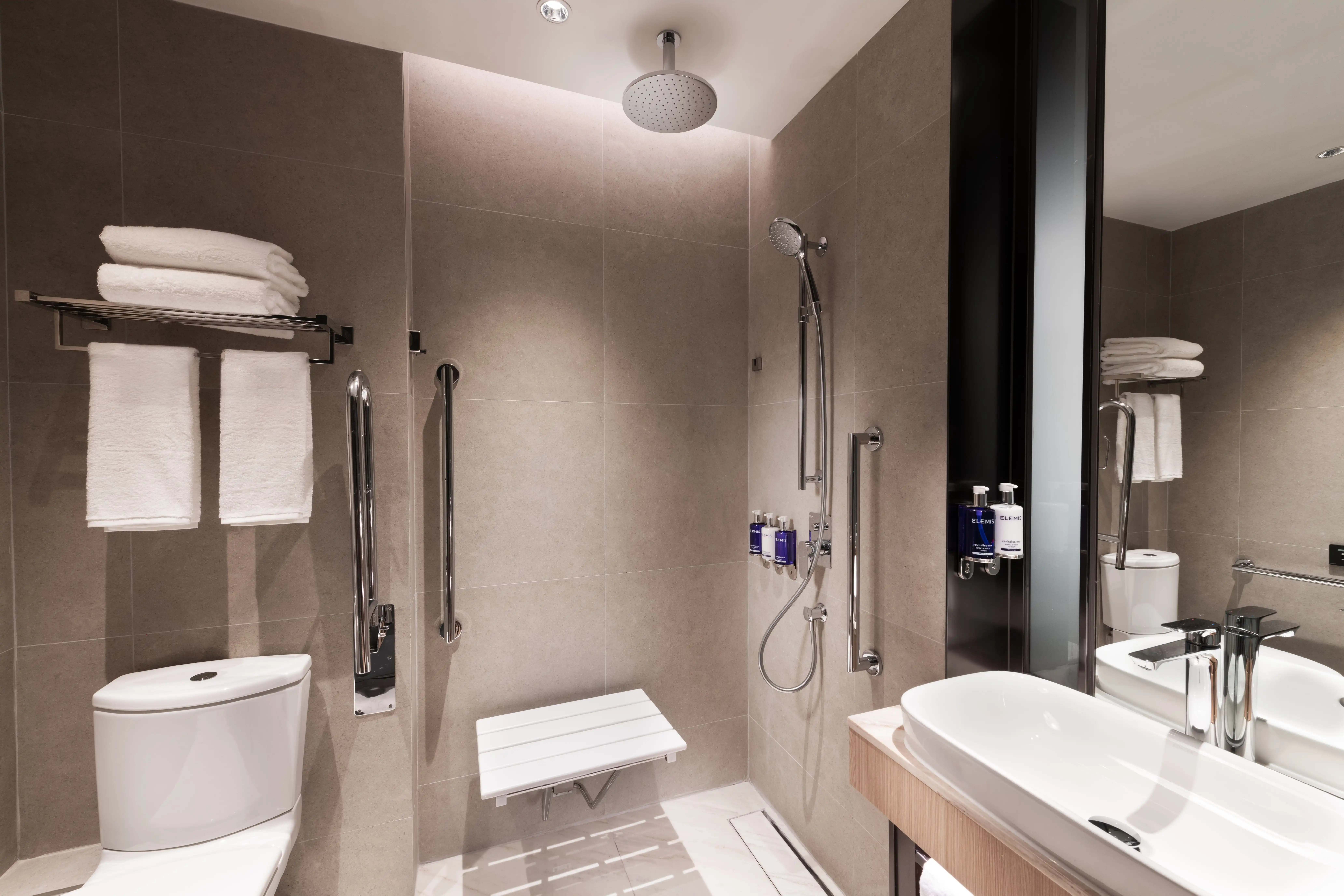A modern, accessible bathroom at Dorsett Kai Tak hotel in Hong Kong with stylish design