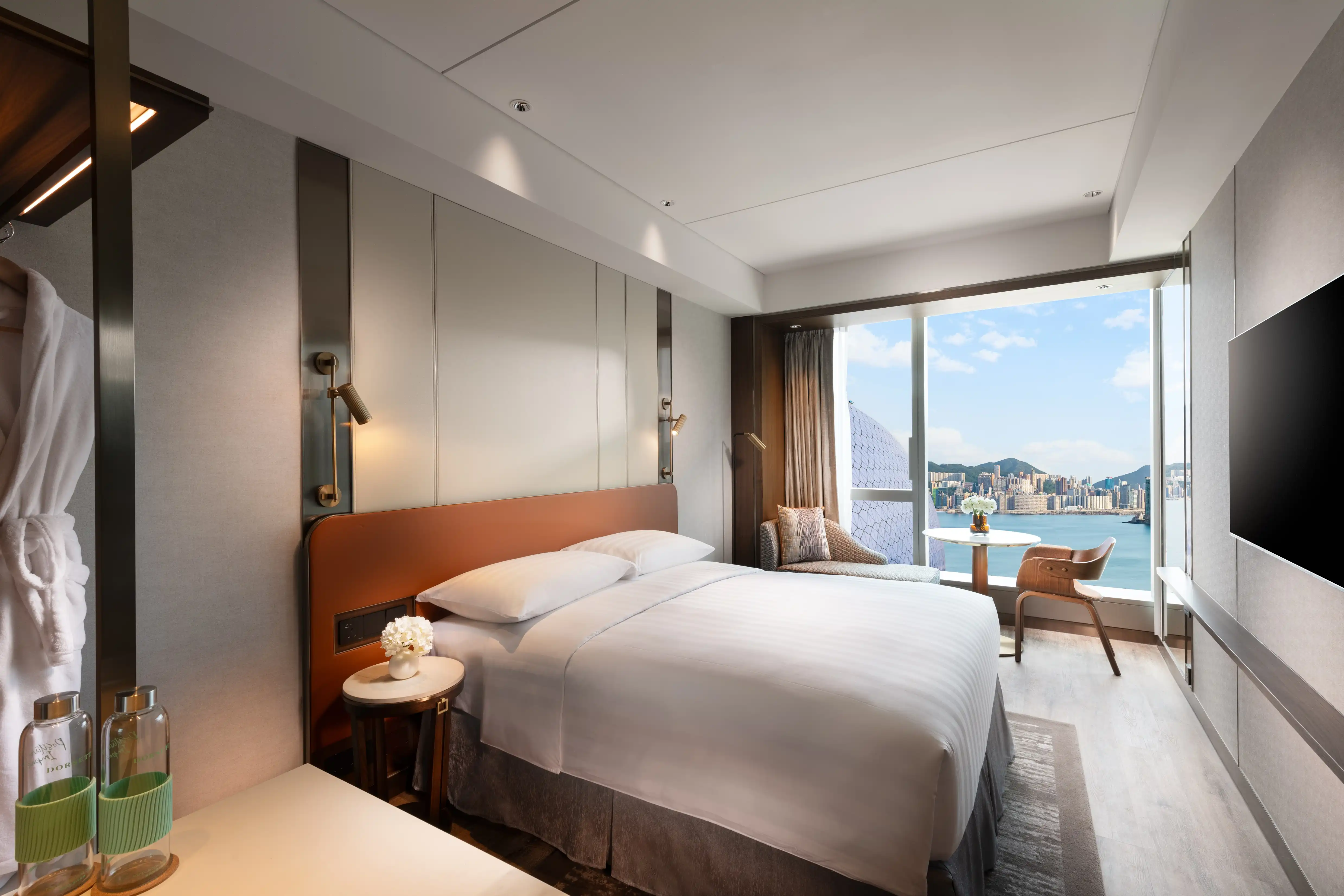 Modern guest room at Dorsett Kai Tak in Hong Kong with panoramic Victoria Harbour views