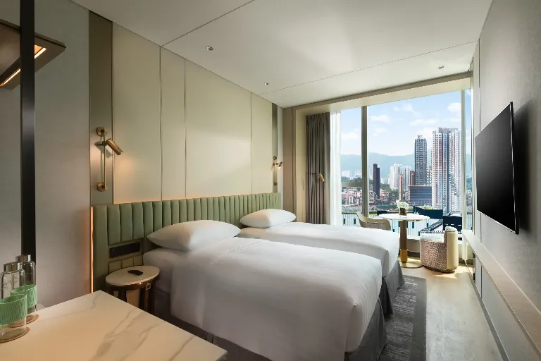 Twin room at Dorsett Kai Tak hotel in Hong Kong with modern amenities and city views