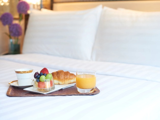 Food and beverages in a bedroom at Dorsett Kwun Tong Hotel.