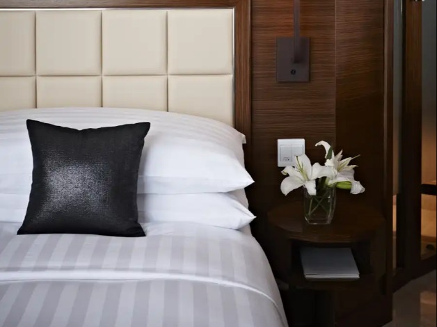 Black cushion on a bed in a Dorsett Kwun Tong Bedroom.