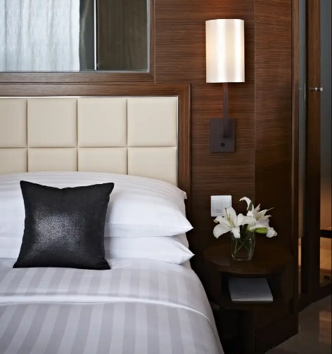 Black cushion on a bed in a Dorsett Kwun Tong Bedroom.